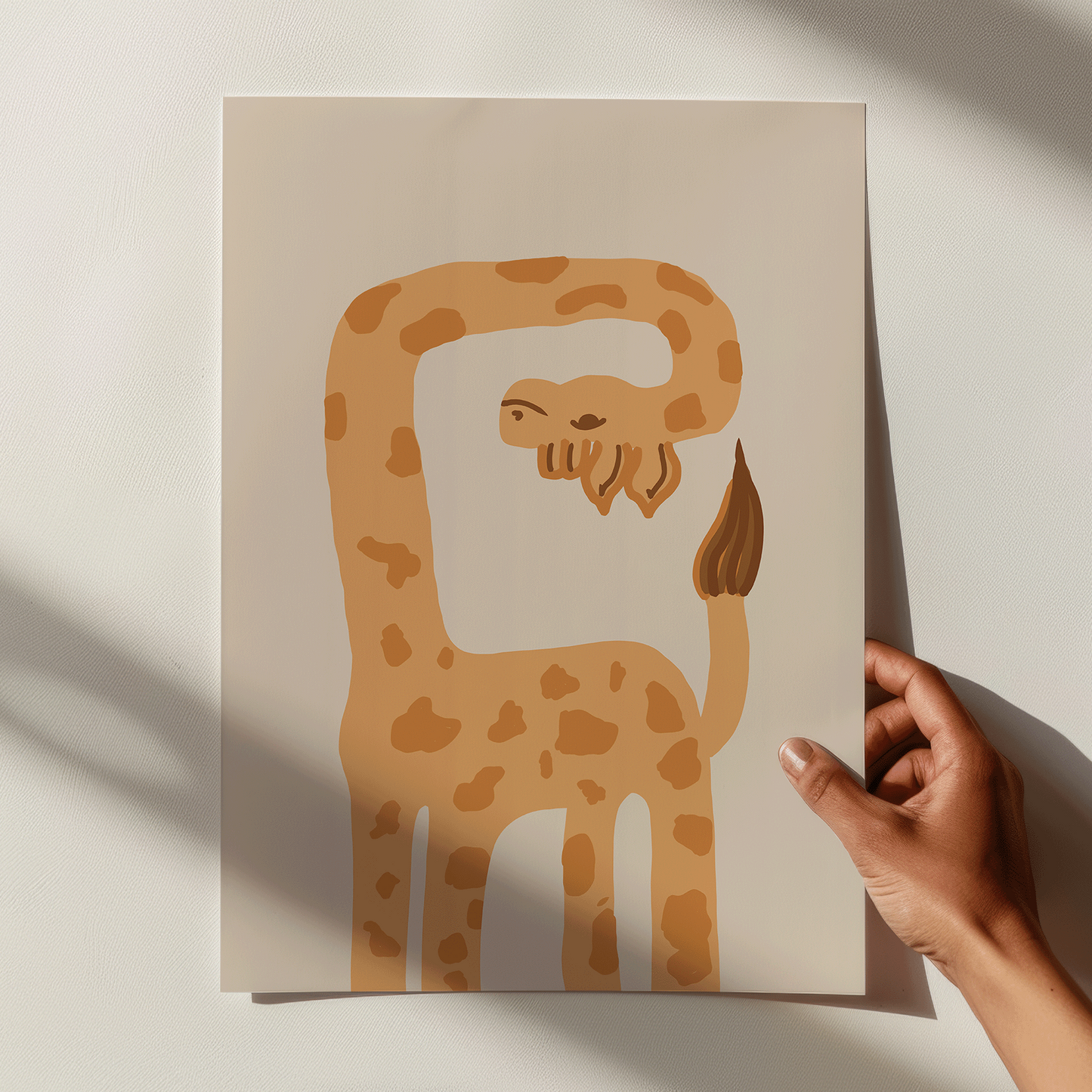 Hand holding a card with a giraffe illustration on a light background