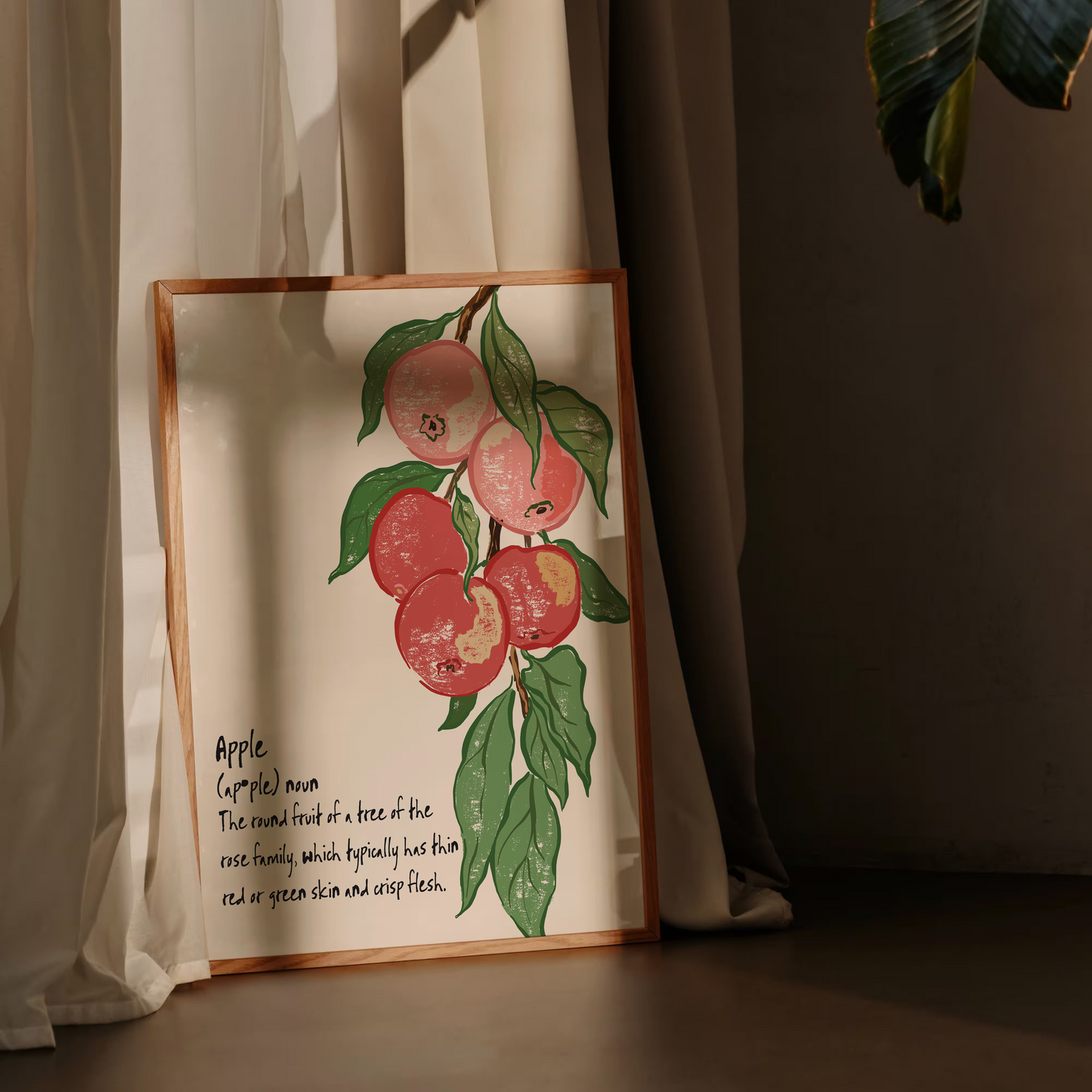 art print with apple design and text against a curtain background