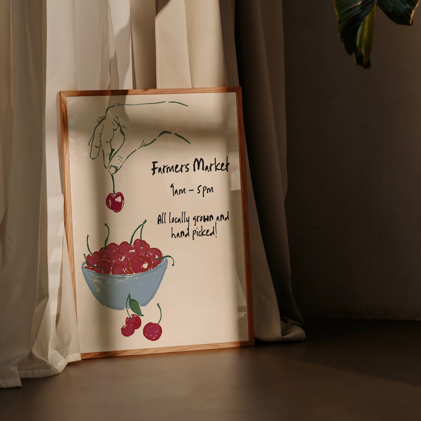 Decorative sign with cherry illustration and text leaning against a curtain.