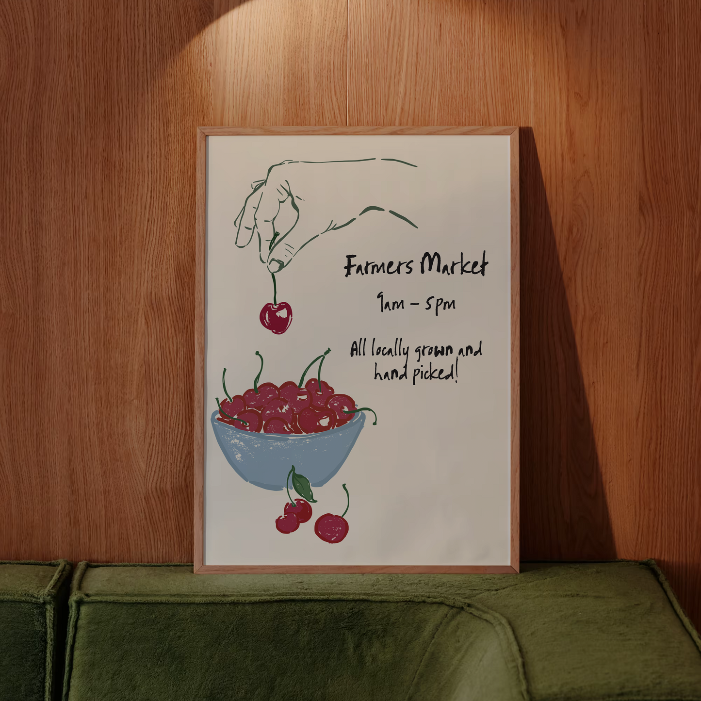 Poster of a hand holding cherries above a bowl with text on a wooden wall.
