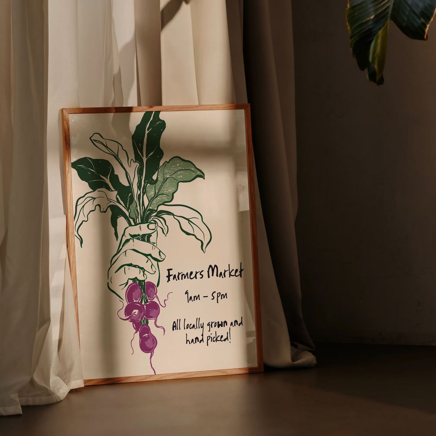 Framed artwork of a plant and grapes on a wall with curtains and leaves in the background