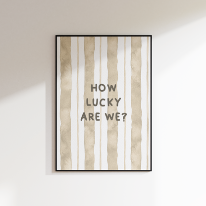 Framed artwork with 'HOW LUCKY ARE WE?' text on a striped background