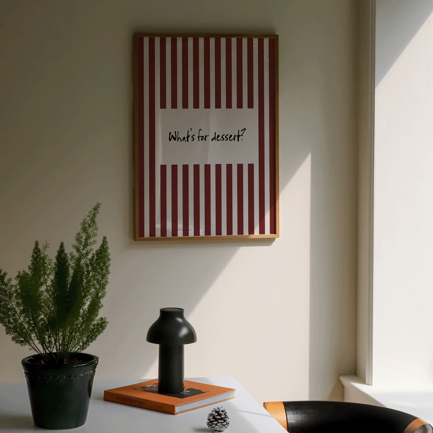 Room interior with a table, chair, and framed picture on the wall.