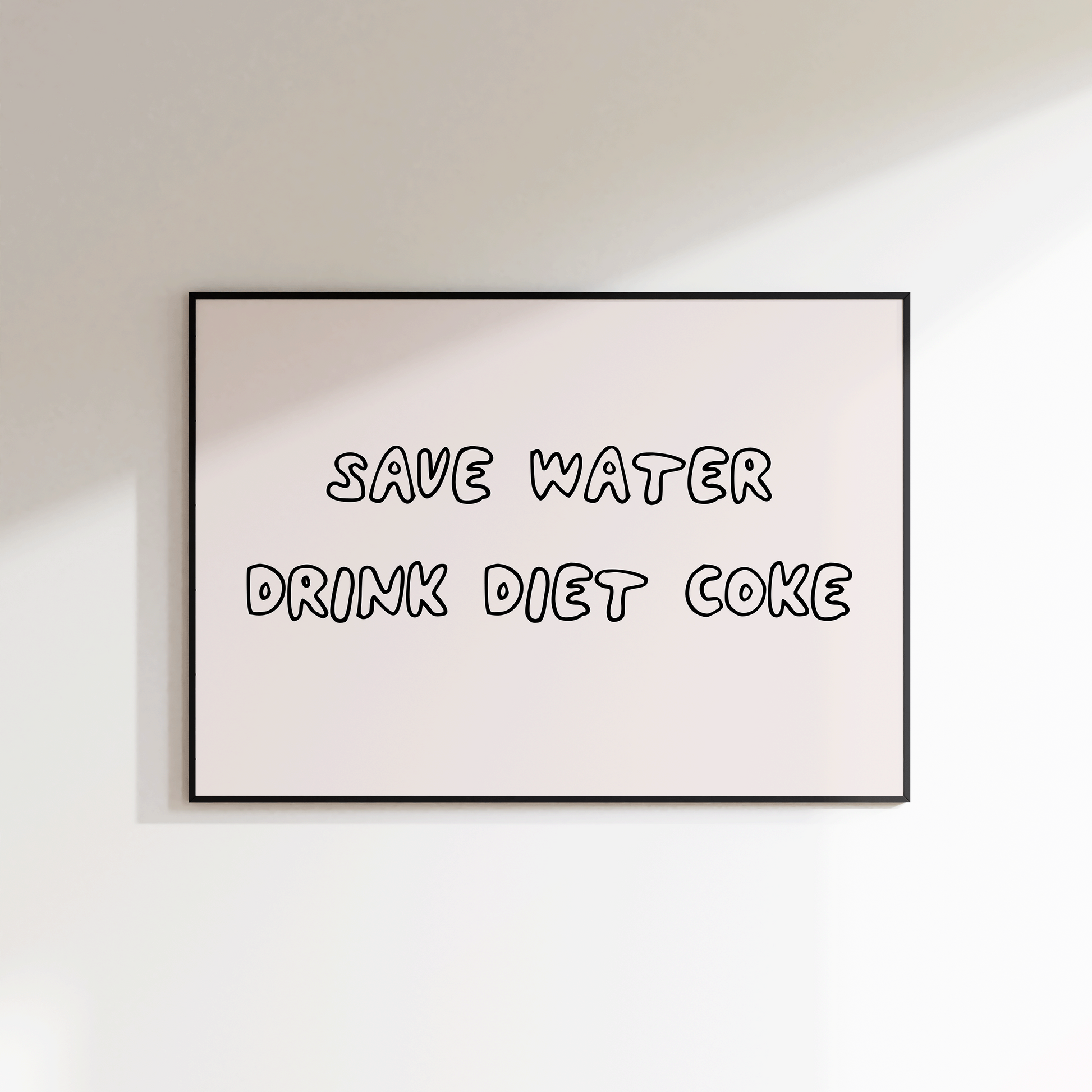 Framed poster with 'Save water, drink Diet Coke' text on a white wall.