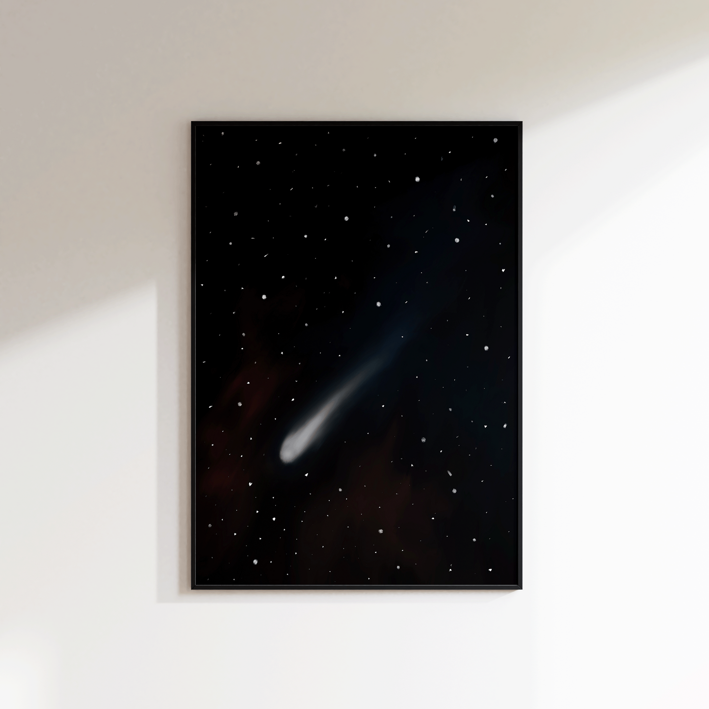 Framed artwork of a comet in space on a white wall