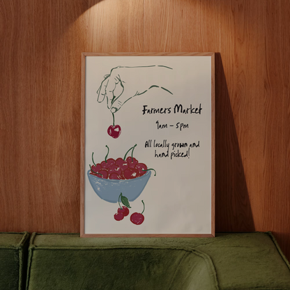 Poster of a hand holding cherries above a bowl with text on a wooden wall.