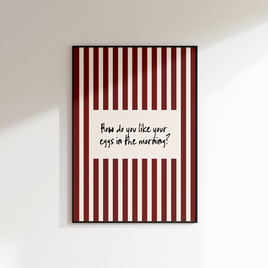 Framed artwork with red and white striped border and text on a white wall.