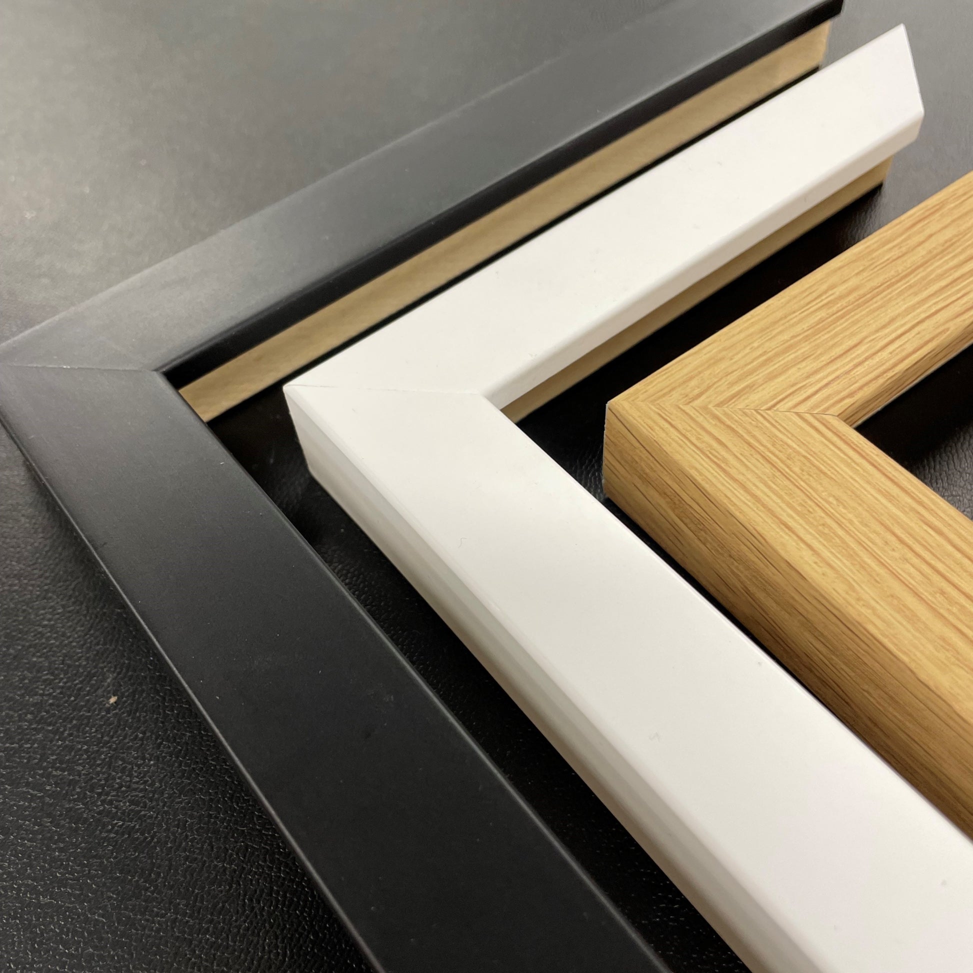 three different frame materials: black, white, and brown.
