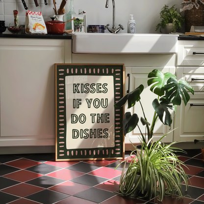 Kitchen with checkered floor, plant, and framed sign reading 'Kisses if you do the dishes'.
