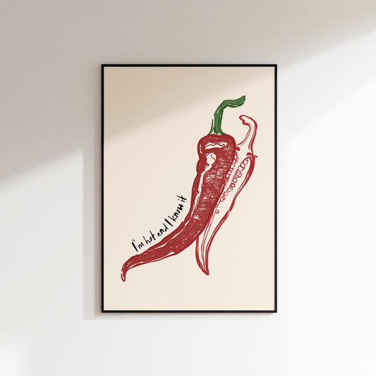 Framed artwork of a red chili pepper on a beige background