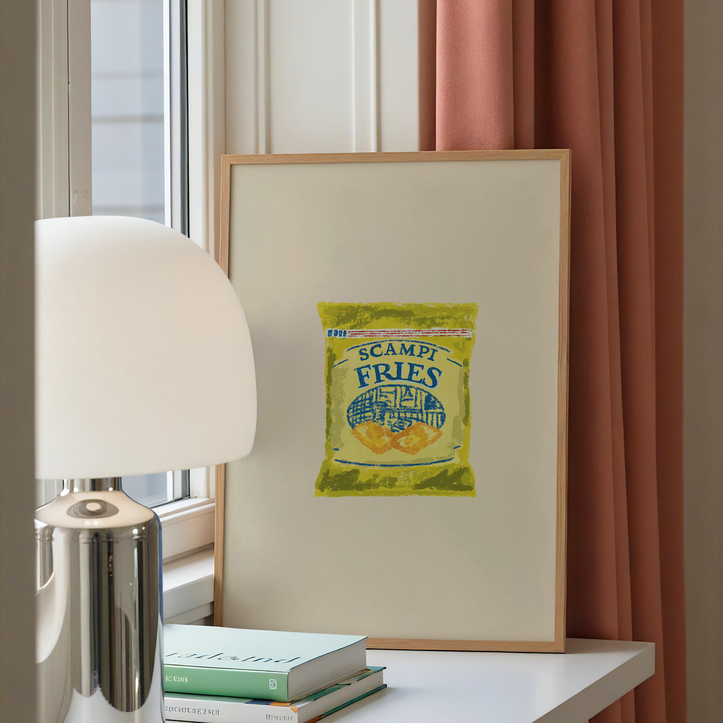 A framed art print featuring a vintage-style illustration of a bag of 'Scampi Fries' leaning on a white table next to a silver lamp and books, with a window and pink curtains in the background.