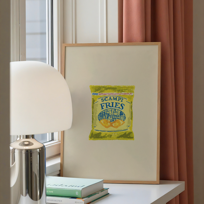 A framed art print featuring a vintage-style illustration of a bag of 'Scampi Fries' leaning on a white table next to a silver lamp and books, with a window and pink curtains in the background.