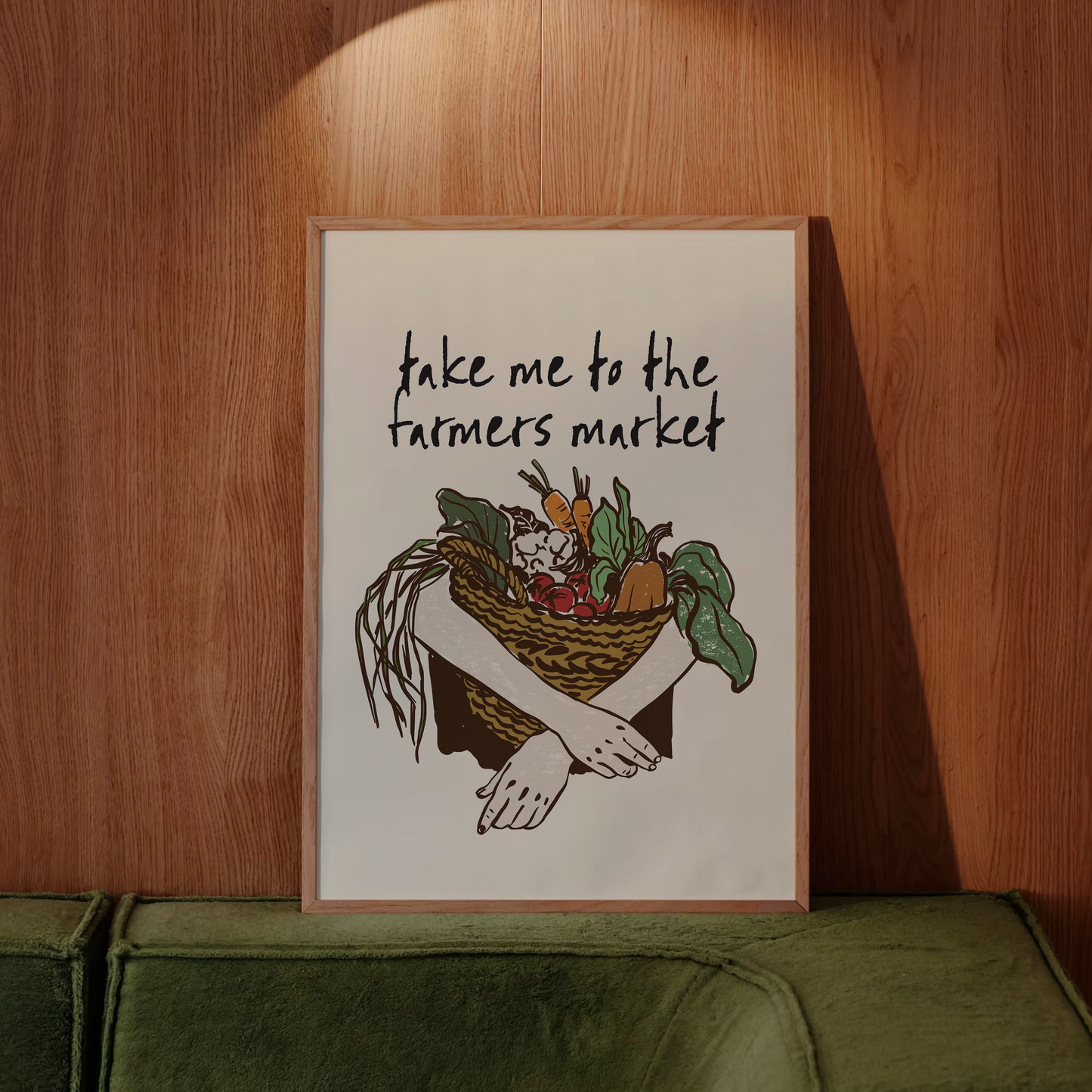 Framed artwork with text 'take me to the farmers market' and a basket of vegetables on a wooden wall.
