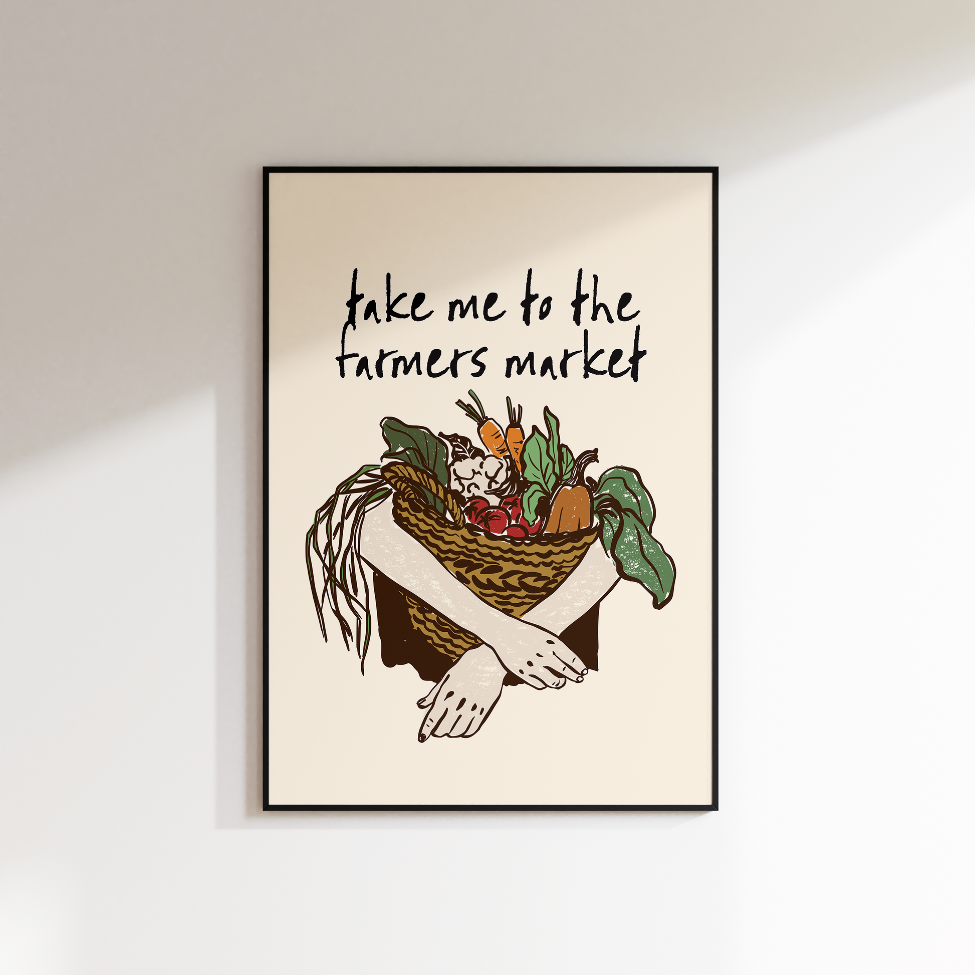 Framed artwork with a basket of vegetables and text 'take me to the farmers market' on a beige background.