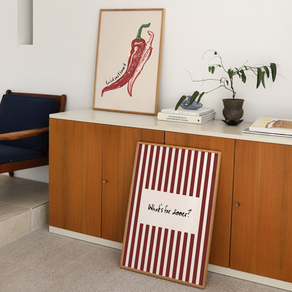 Room interior with a wooden cabinet, framed artwork, and a striped sign.